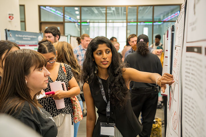 Female Professor Presenting Poster