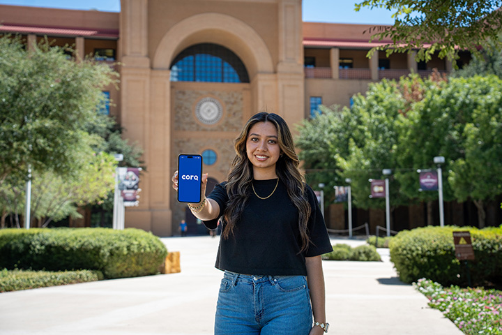 Student Displaying CORQ App in Front of CAB